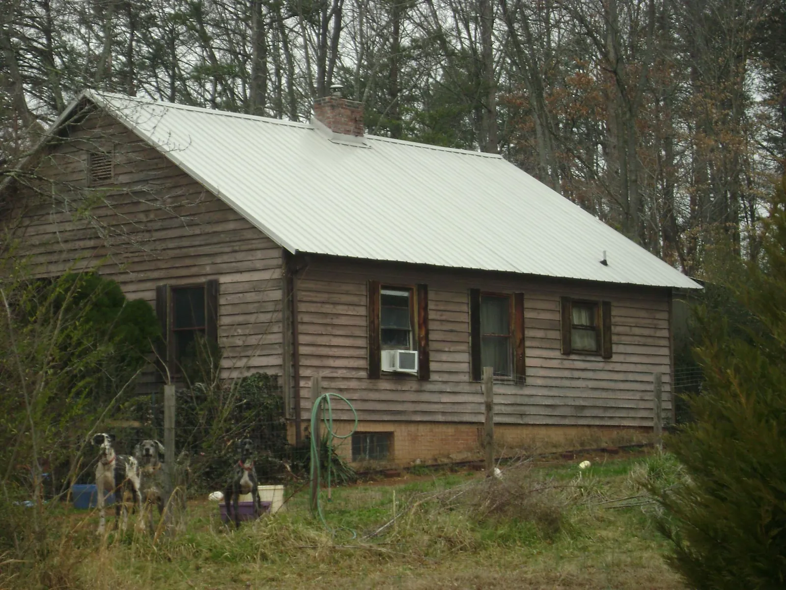 White metal roof on an old wood sided farmhouse, from a Metal Roof Installation job in Nineveh